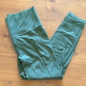 Athleta Salutation stash-pocket.  High-Waist Pocket Leggings in army green.